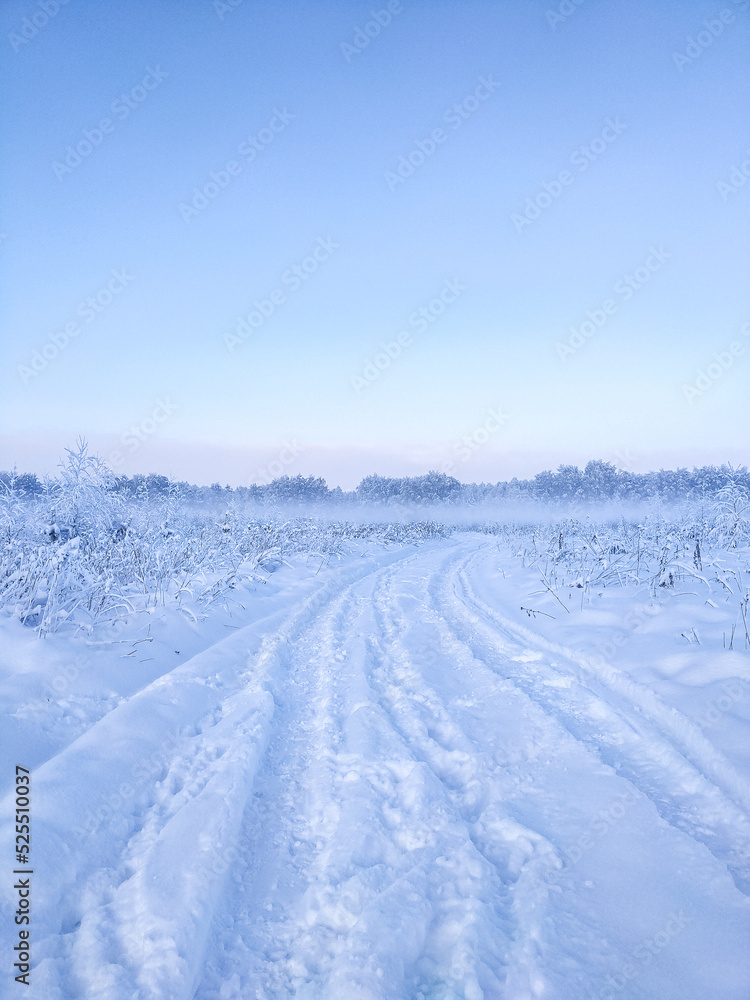Snow covered foggy road in early frosty morning Snow covered foggy road in early frosty morning