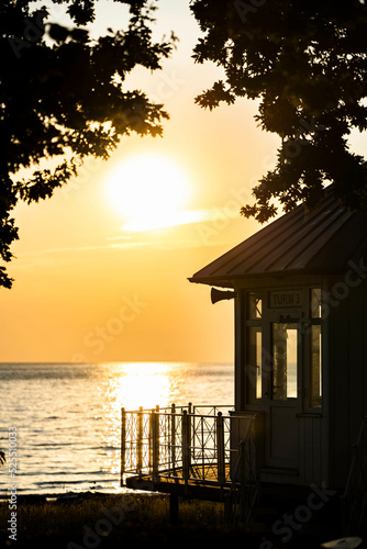 Ein Rettungsturm der DLRG bei Sonnenaufgang an der Strandpromenade in Binz auf Rügen an der Ostsee photo