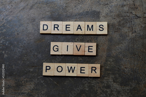dreams give power text on wooden square, inspiration and motivation quotes