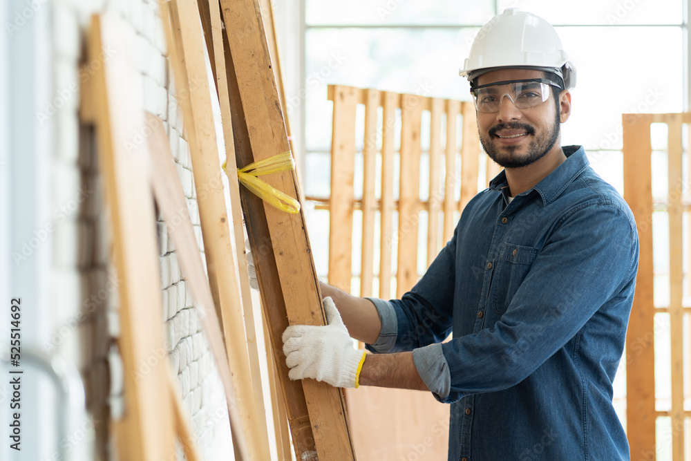 Carpenter man working in the wood workshop. Male carpenter worker wear safety equipment tool works at the carpentry shop Carpenter man working in the wood workshop. Male carpenter worker wear safety equipment tool works at the carpentry shop