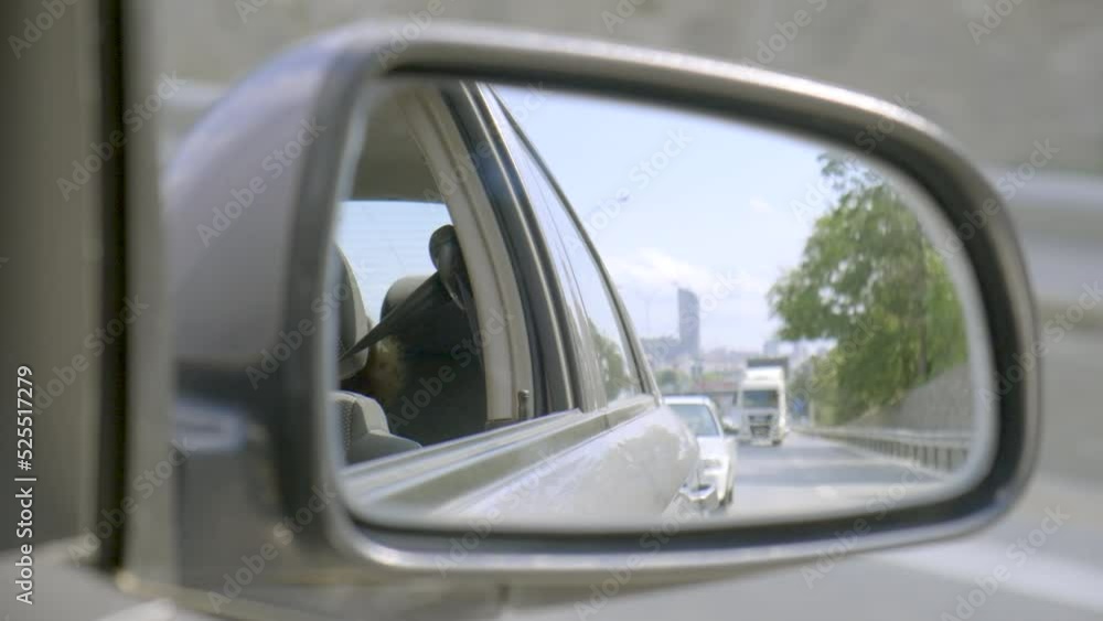 Reflections in the side mirror of a car on the highway. There is a truck in the side mirror Reflections in the side mirror of a car on the highway. There is a truck in the side mirror