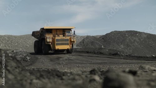 Empty dump truck moves quickly to load coal. Movement towards the camera.