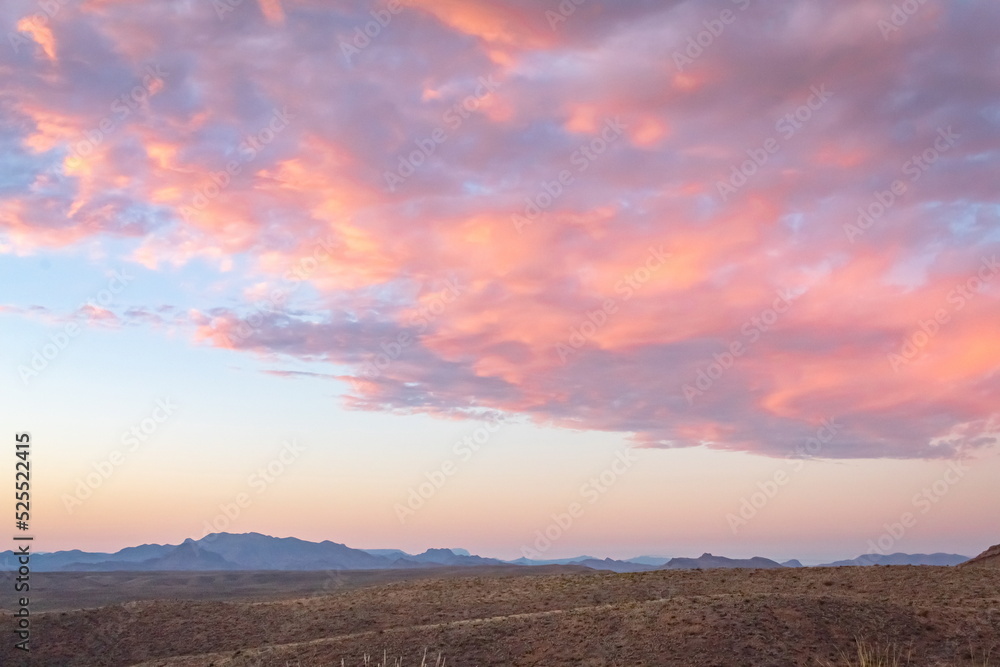 Dramatic pink sunset over the grass fields in the Big Bend National Park Desert in Texas
