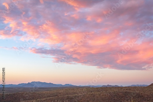 Dramatic pink sunset over the grass fields in the Big Bend National Park Desert in Texas