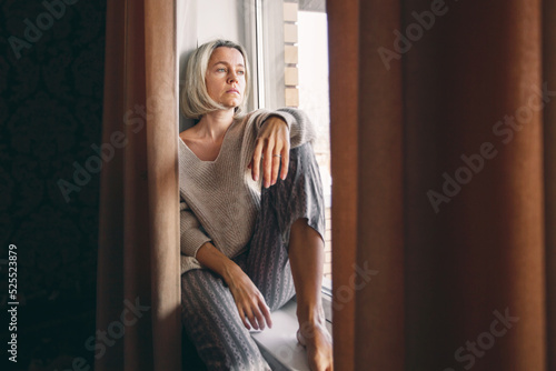 Obraz na płótnie Sad pensive adult 40s woman at home