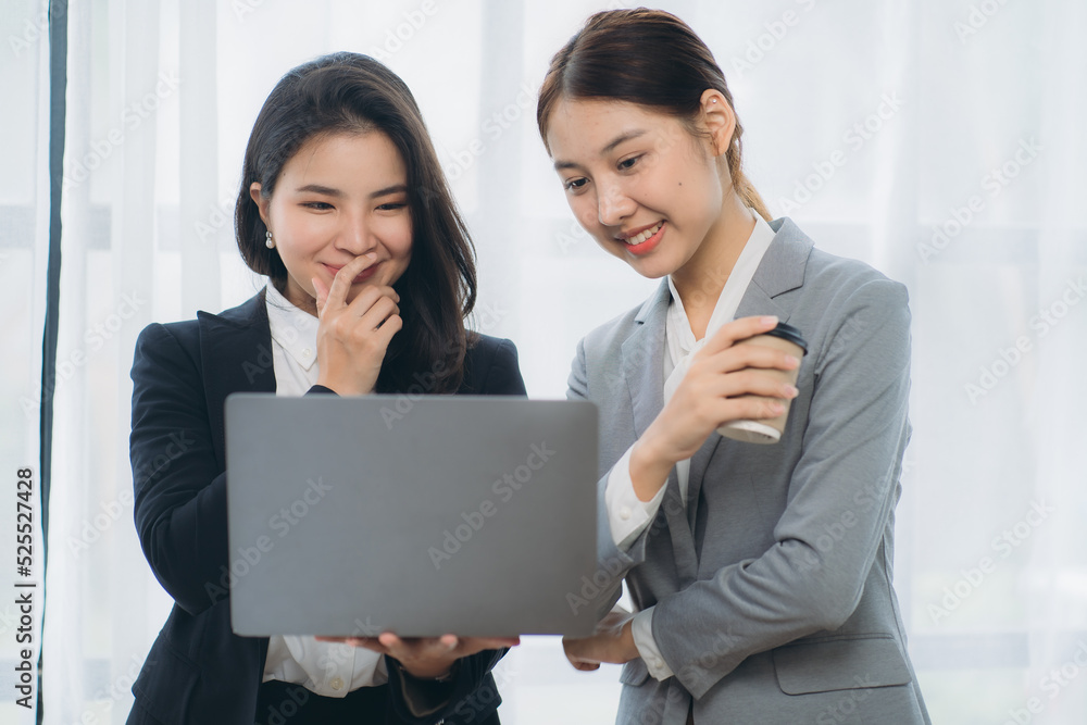 Two asian business woman work together to get the job done at the office. Two asian business woman work together to get the job done at the office.