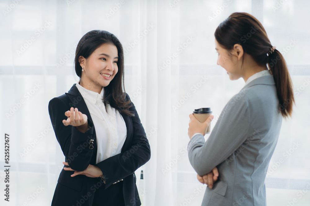 Two asian business woman work together to get the job done at the office