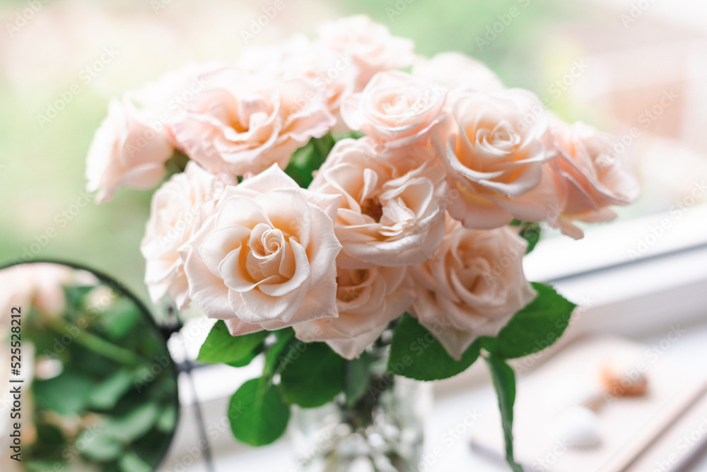 Bouquet of roses on the windowsill in the interior of the bedroom. Bouquet of roses on the windowsill in the interior of the bedroom.