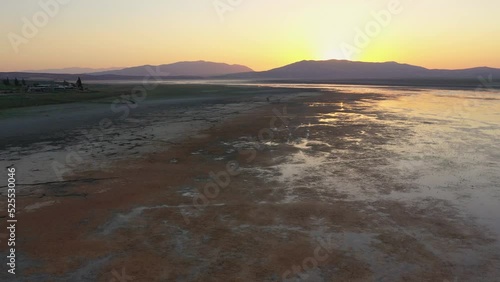 Wallpaper Mural Aerial footage of a dry lake with many birds in with orange colored sunset light Torontodigital.ca