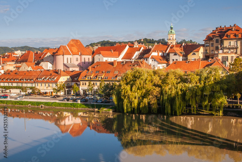 Lent district in Maribor, Slovenia. Popular waterfront promenade with historical buildings and the oldest grape vine in Europe. photo