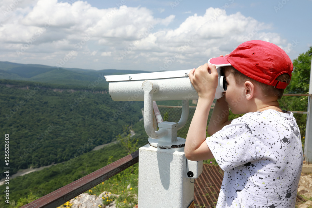 Kid looking through binoculars at valley of Belaya River from Una-koz ridge