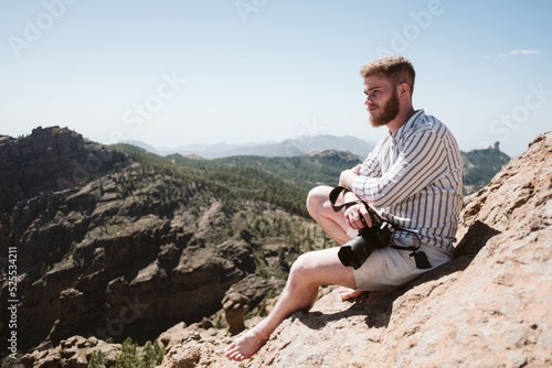 Photographer taking photos in a mountainous landscape photo