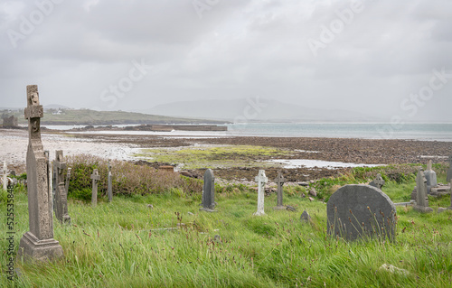 Graves in Ballinskelligs Abbey graveyard on the Iveragh peninsula, County Kerry, Ireland photo