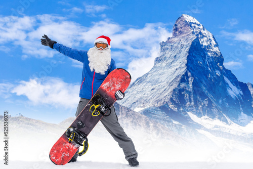 Santa Claus on a snowboard. Man in a red suit Santa Claus with a white beard in a ski mask jumped on a snowboard. The ski slope