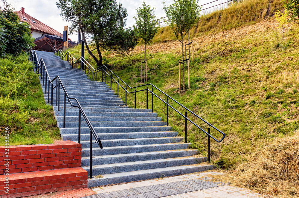 stairs with metal railings up the slope