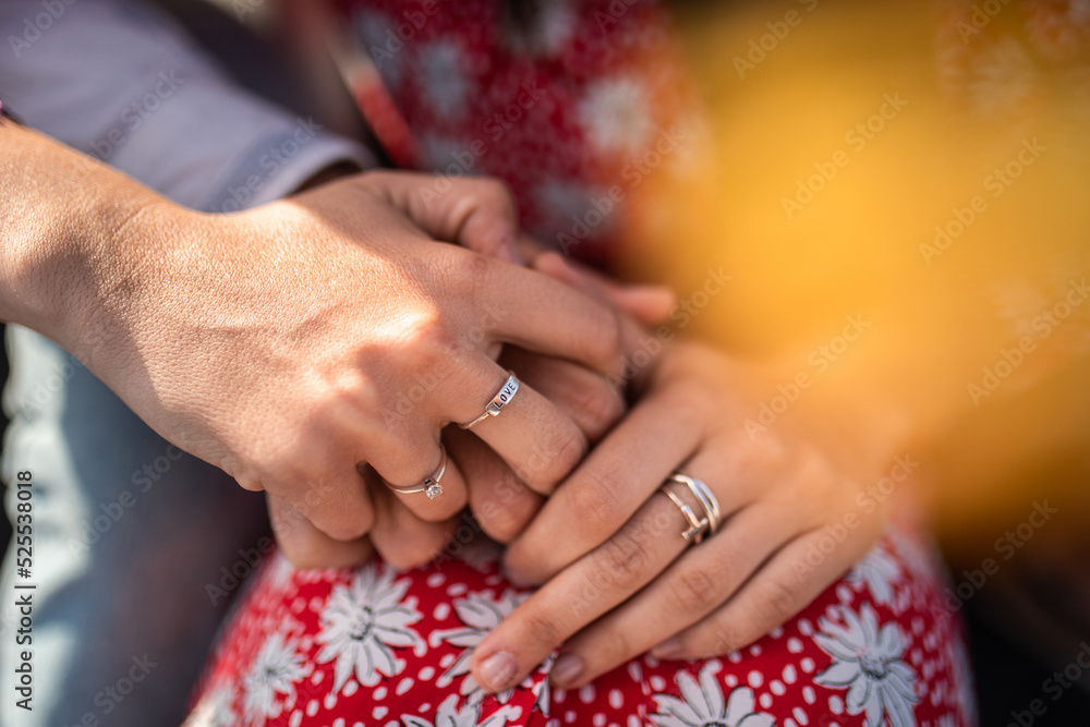Crop couple holding hands and cuddling in sunlight Crop couple holding hands and cuddling in sunlight