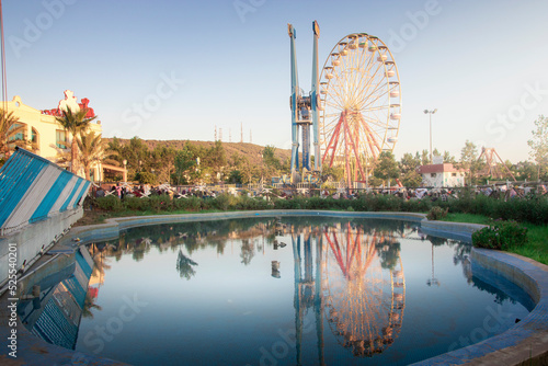 cityscape for an amusement park and children games with nice ferris wheel , mostaland park in Mostaganem Algeria , algeria park photo