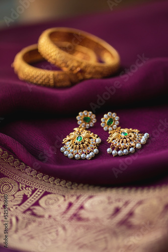 Gold earring on a purple traditional indian saree