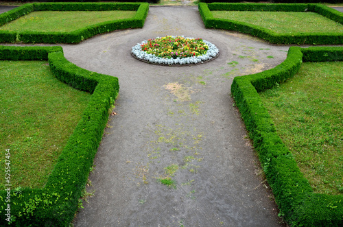 cut hedges into various geometric shapes. Strictly cut evergreen parterres and bosquettes are part of every historic Baroque French garden. some large formations resemble smooth granite boulders photo