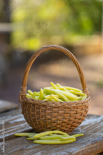 yellow string beans in a wooden basket