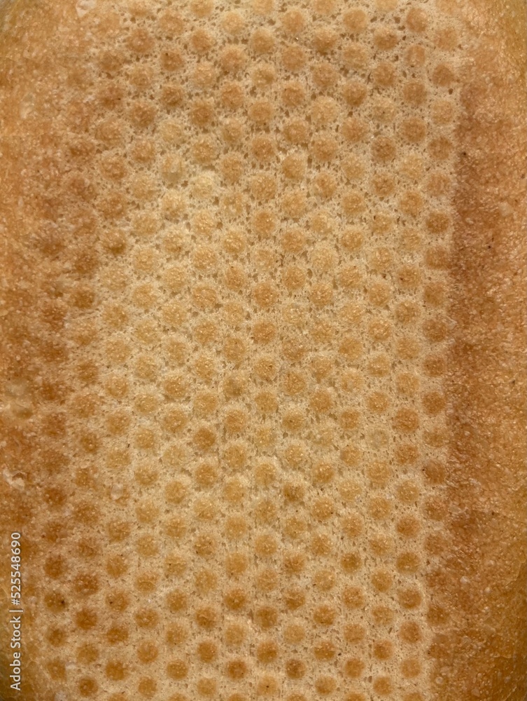 The bottom of a baked crispy roll The bottom of a baked crispy roll