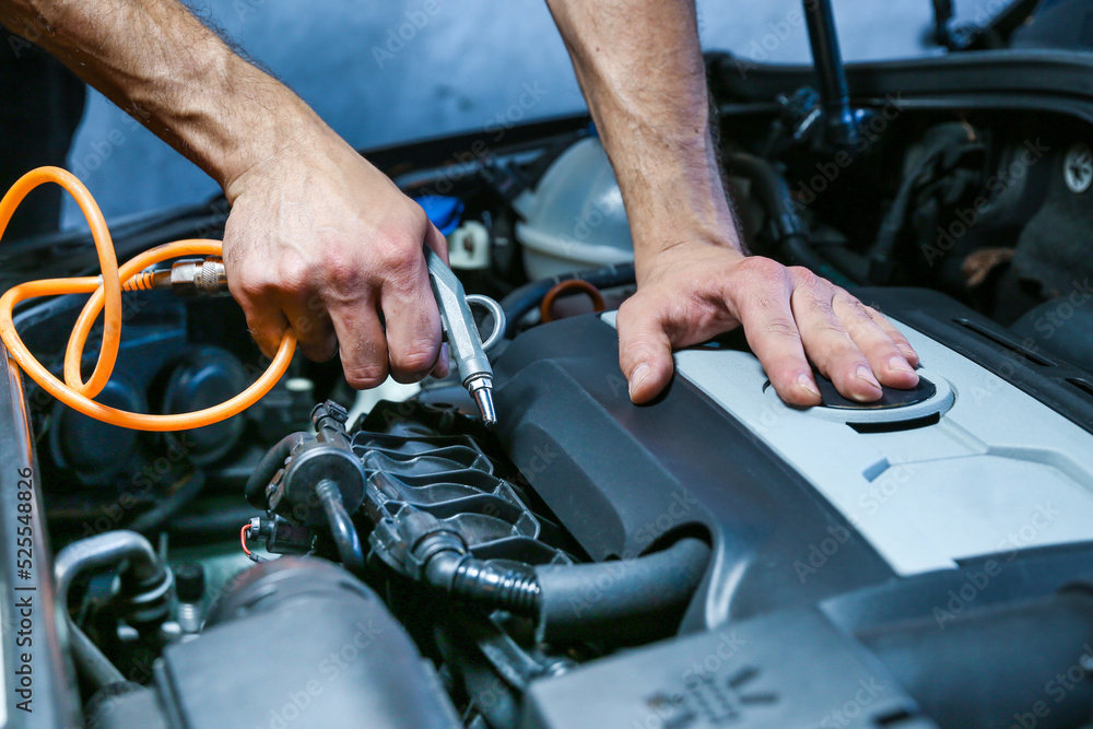 blowing out the engine with compressed air after washing. dry cleaning car engine blowing out the engine with compressed air after washing. dry cleaning car engine