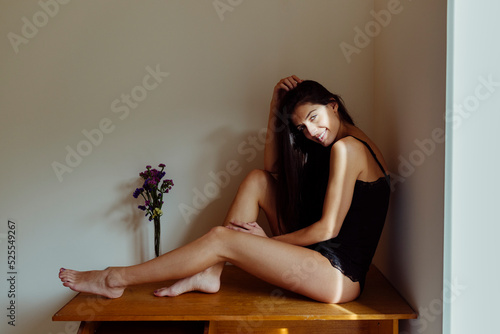 Charming Hispanic lady on table in room