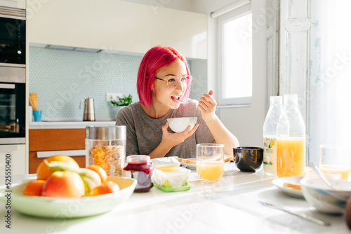 Young lady having healthy breakfast at home photo