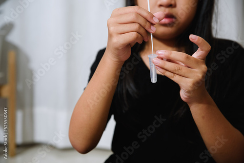 Asian girl preteen girl getting swab test at home, Covid quick rapid self test, kid antigen test