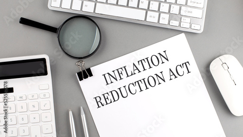 Inflation Reduction Act written on paper with office tools and keyboard on the grey background photo
