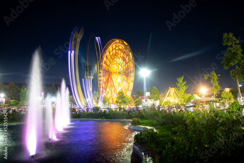  cityscape at night for an amusement park and children games with nice ferris wheel , mostaland park in Mostaganem Algeria , algeria park photo
