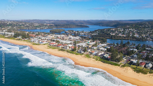 Aerial drone view of Collaroy Narrabeen Beach on the Northern Beaches of Sydney, NSW, Australia with views of South Creek and Narrabeen Lagoon in the background on a sunny day 