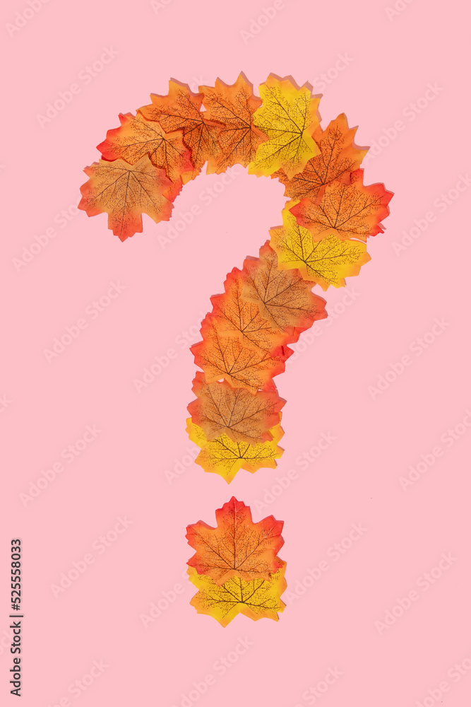 Autumn creative layout made with leaves forming question mark on pastel ...