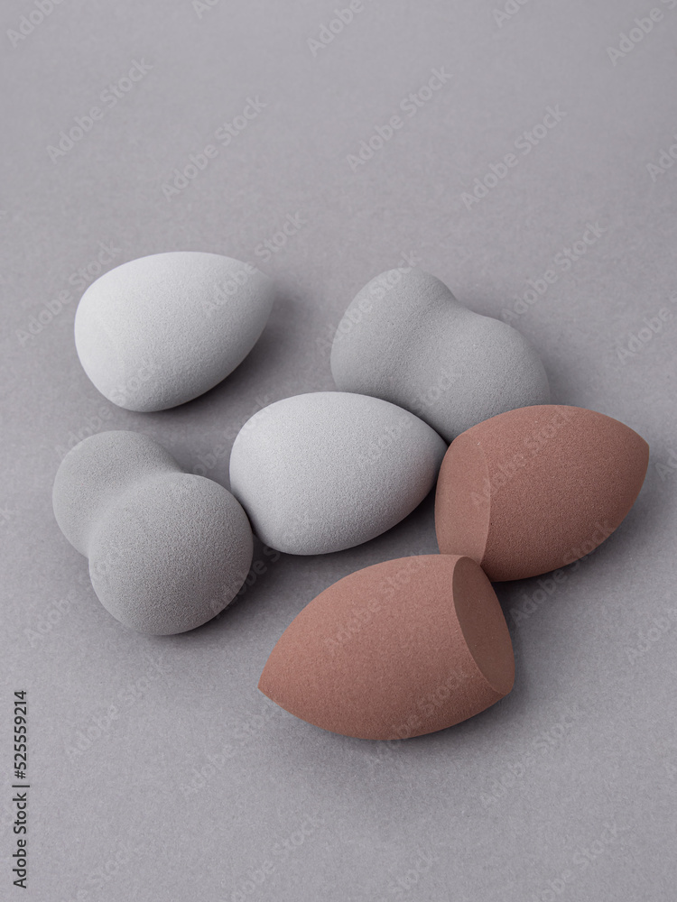 Set of different makeup soft sponges on gray background. Make up egg tool Set of different makeup soft sponges on gray background. Make up egg tool