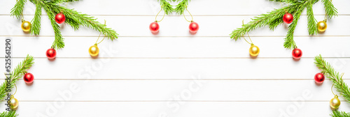 Christmas banner. Christmas concept with fresh spruce tree and baubles on white wooden background. Copy space