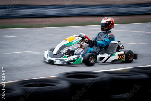 Go kart racing field, racer wearing safety uniform on competition tournament.  © APchanel