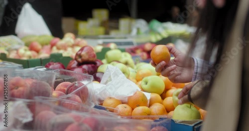 CU Female couple picking fruit in farmers market