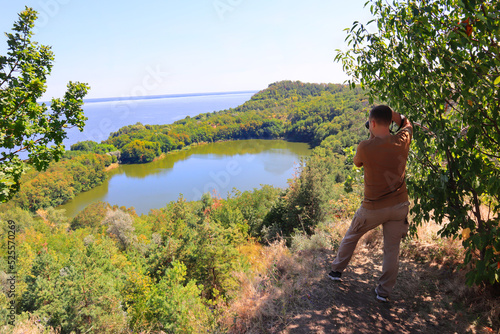 Man takes picture of view of Buchak Lake in Cherkasy region, Ukraine	
 photo