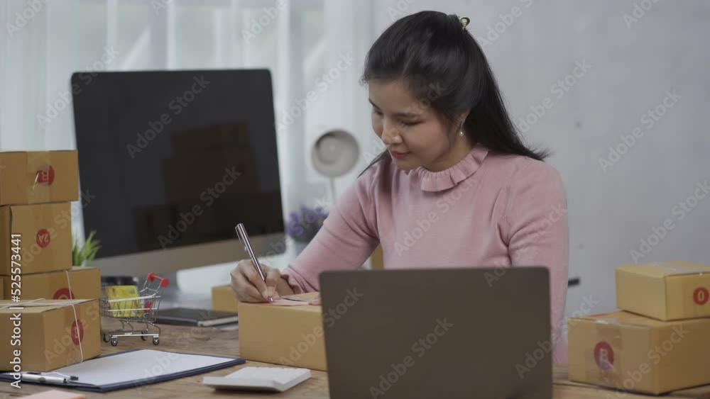 Asian woman working with laptop keyboard check online order check goods stock delivery parcel courier postage asian woman start small sme business at home Asian woman working with laptop keyboard check online order check goods stock delivery parcel courier postage asian woman start small sme business at home