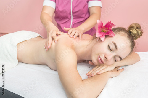 Young beautiful woman getting relaxing back and body massage