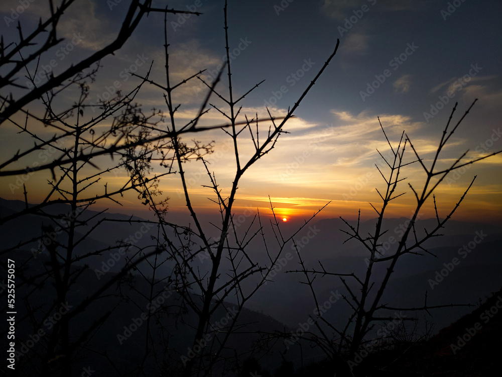 Dehradun, uttarakhand India. Small round Sun at the horizon just before sunset during golden hour. Dehradun, uttarakhand India. Small round Sun at the horizon just before sunset during golden hour.