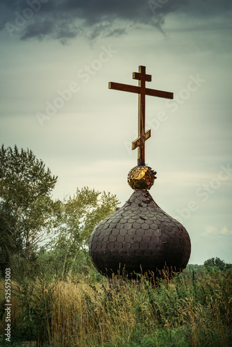 Fotografie, Tablou Old russsian chirch tip with golden cross separate bring down on ground and gras