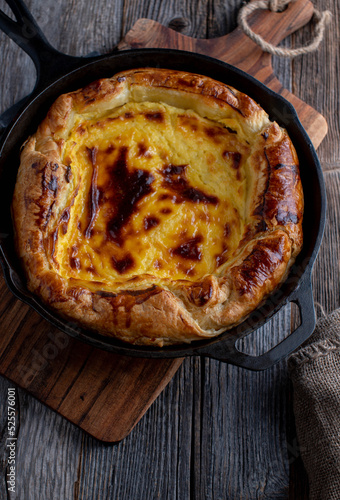 Puff pastry cake with cheesecake filling baked  in a cast iron pan