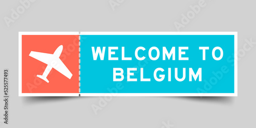 Orange and blue color ticket with plane icon and word welcome to belgium on gray background