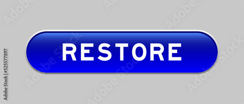 Blue color capsule shape button with word restore on gray background
