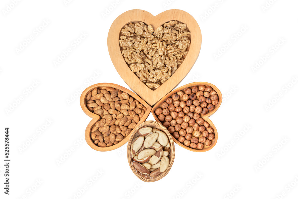 Variety of nuts in wooden cups in the shape of a heart isolated on a white background. Variety of nuts in wooden cups in the shape of a heart isolated on a white background.