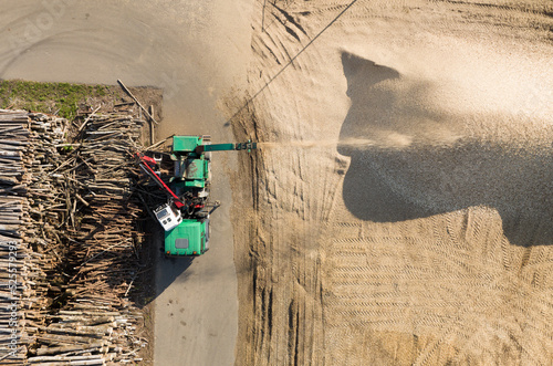 Chipper Machine on Wood Waste Recycling. Shredding Waste Woodshredding. Mobile chipper Truck on Firewood Processing forWood Chips, Sawdust and Fuel Briquettes. Shredder Machine on Timber Recycling photo