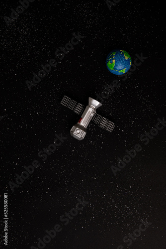 artificial satellite and Earth on space background