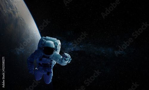 Astronaut and space background. Elements of this image furnished by NASA. photo