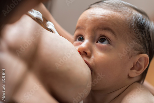 Content mom breastfeeding baby at home photo